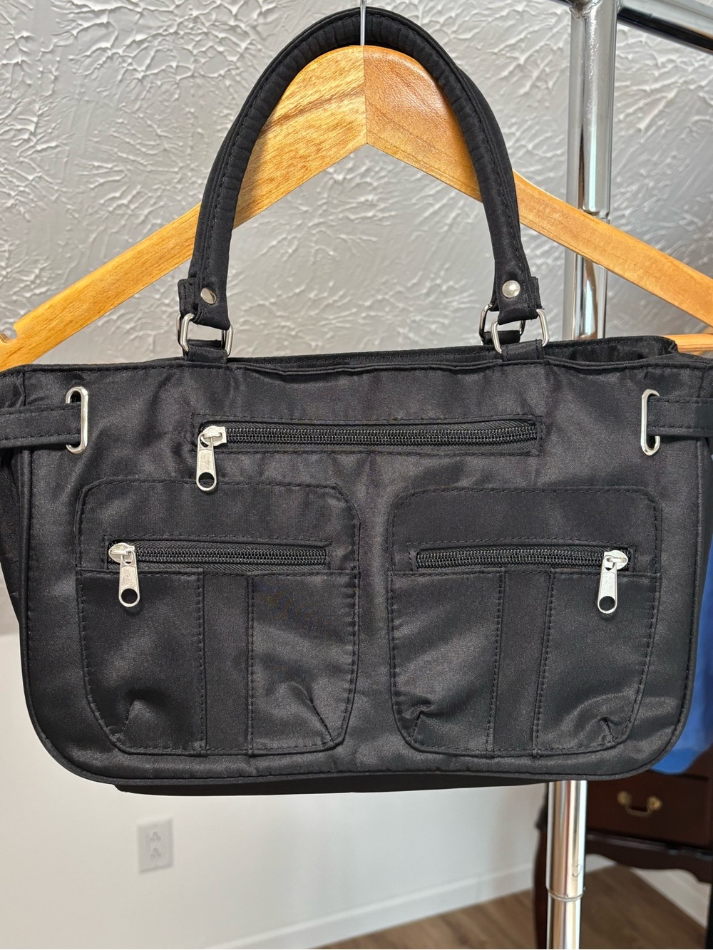 Black utility handbag, polyvinyl blend. Multiple zippered compartments